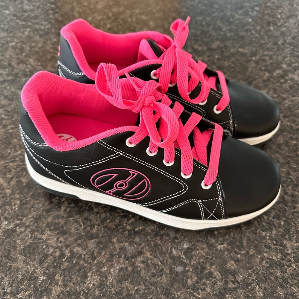 Heely’s skating sneakers, size 5 youth. Worn outside once, black and pink.